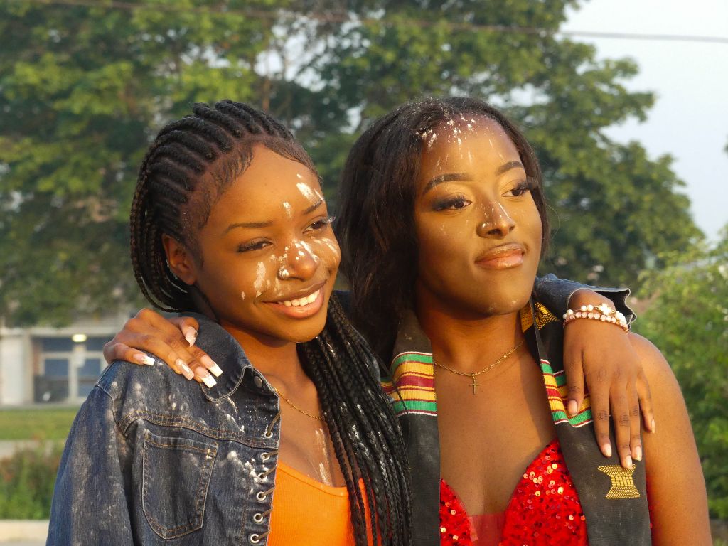 Two women with face paint smiling