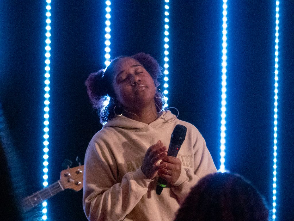 Woman singing with blue LED lights