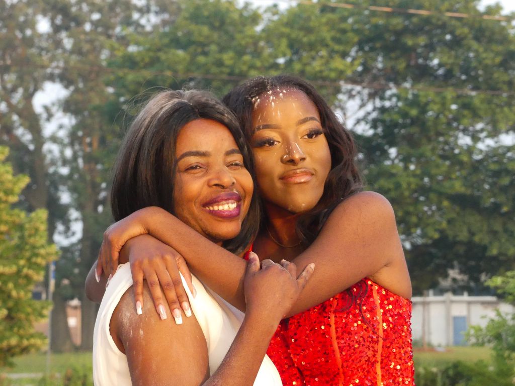 Two women hugging at event