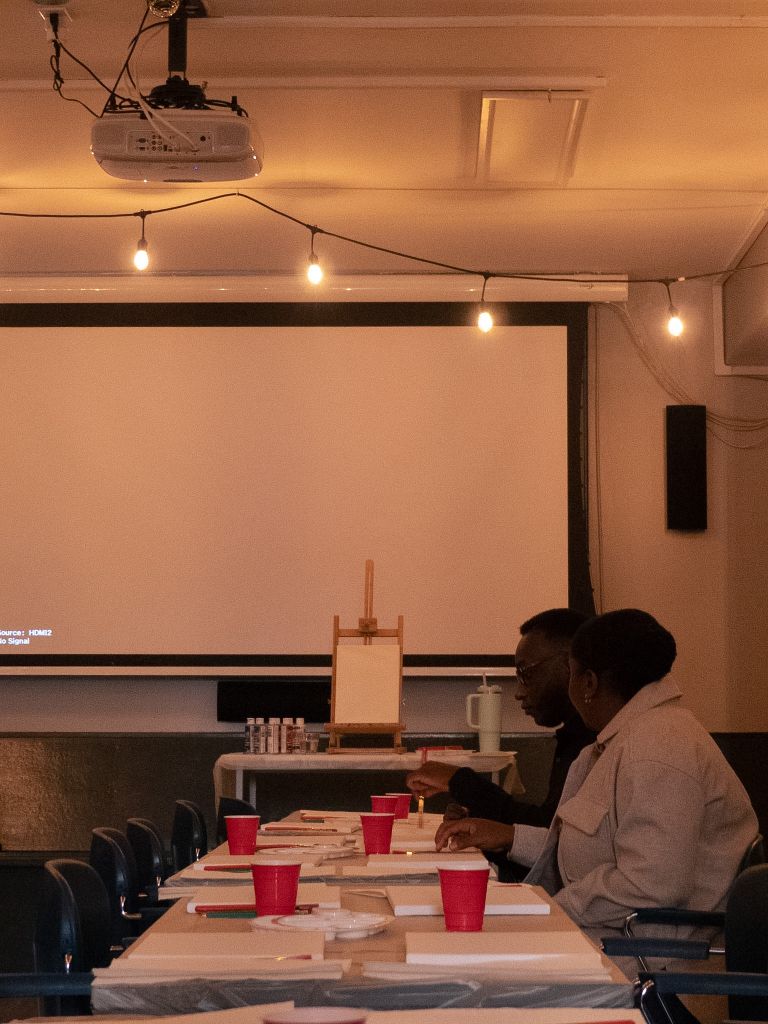 Person at art table with projector screen