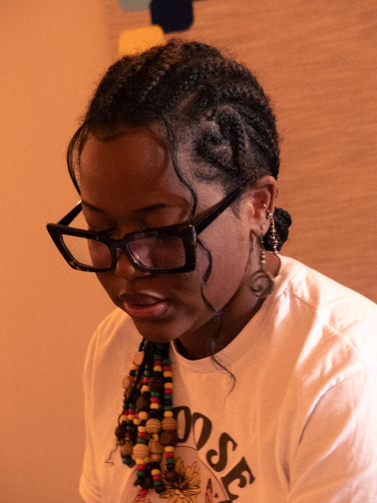 Woman with braids and colorful beaded necklace