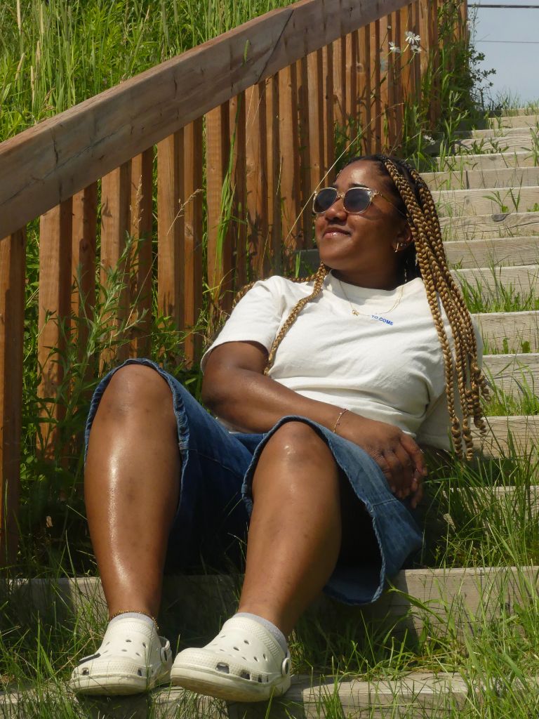 Woman with golden braids sitting on steps