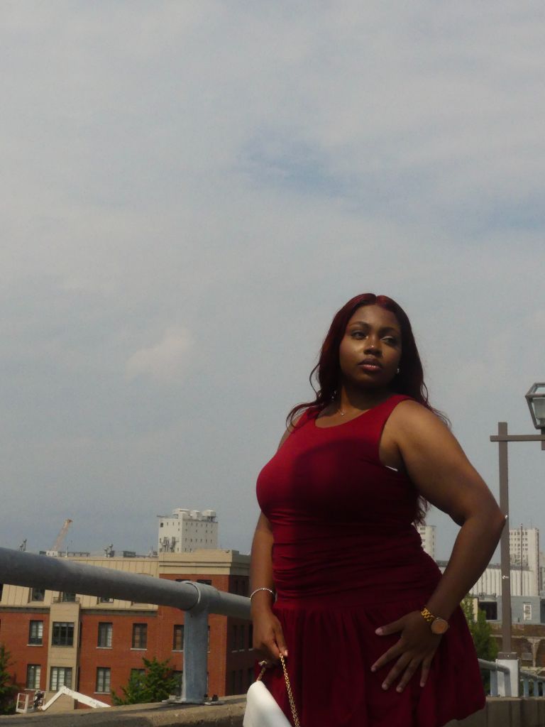 Portrait — Woman in red dress rooftop